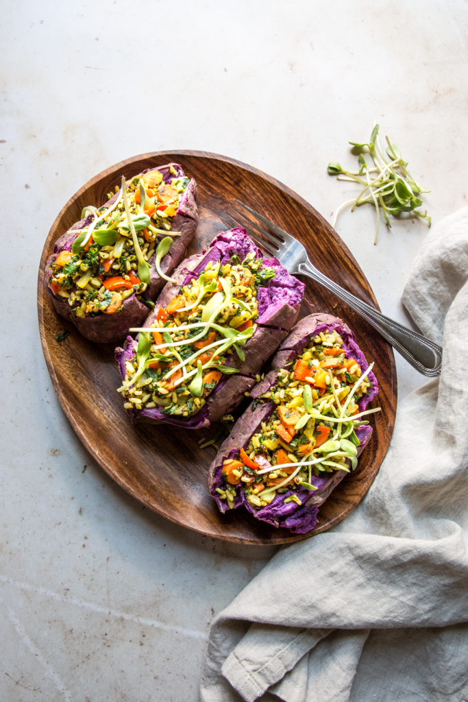 quinoa and rice stuffed purple sweet potatoes with a fork