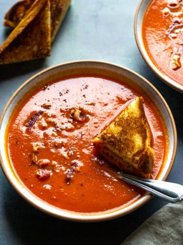 tomato soup in a bowl with a spoon