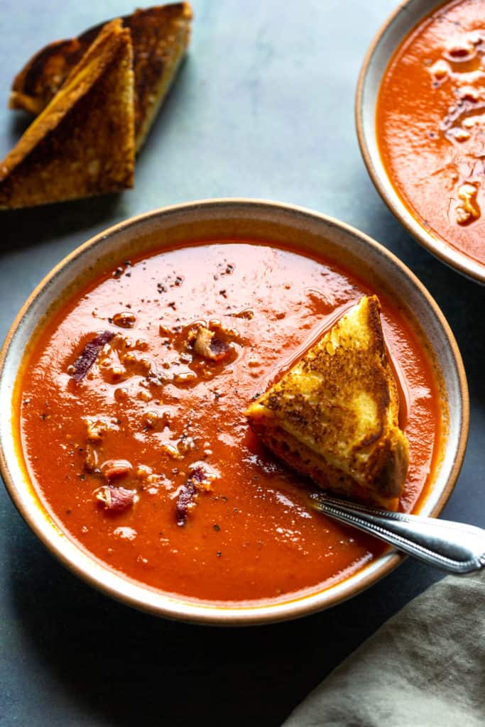 tomato soup in a bowl with a spoon