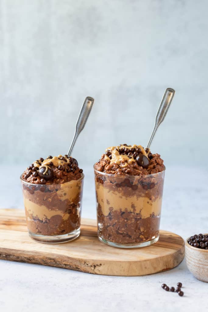 gluten free chocolate peanut butter oatmeal in two glasses with spoons