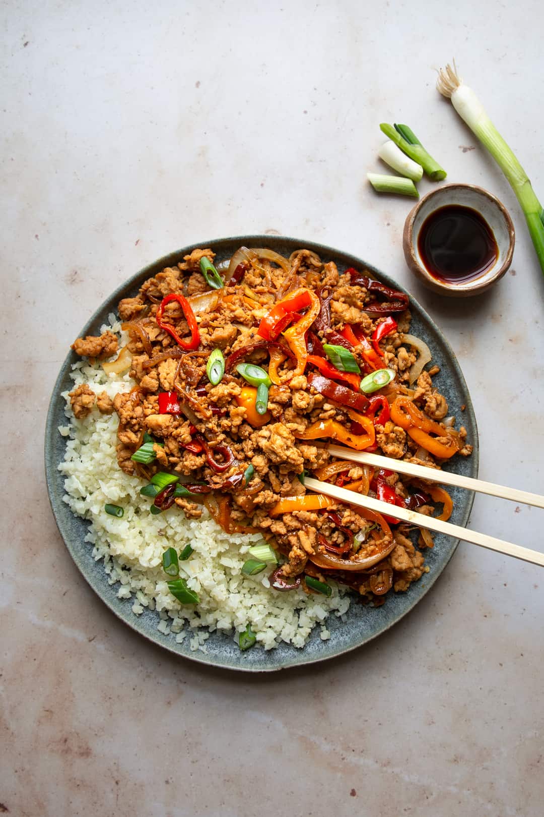 kung pao chicken with chopsticks on a plate 
