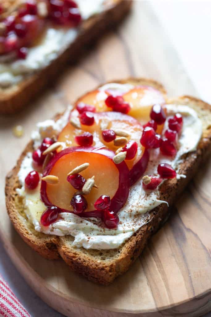 plum toast with pomegranate and cream cheese