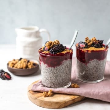 blackberry chia pudding in a glass with a spoon