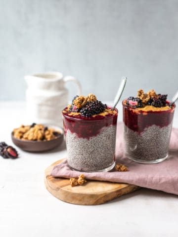 blackberry chia pudding in a glass with a spoon