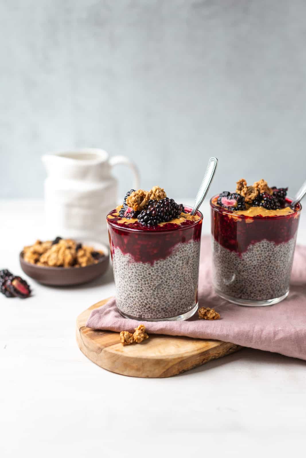 blackberry chia pudding in a glass with a spoon