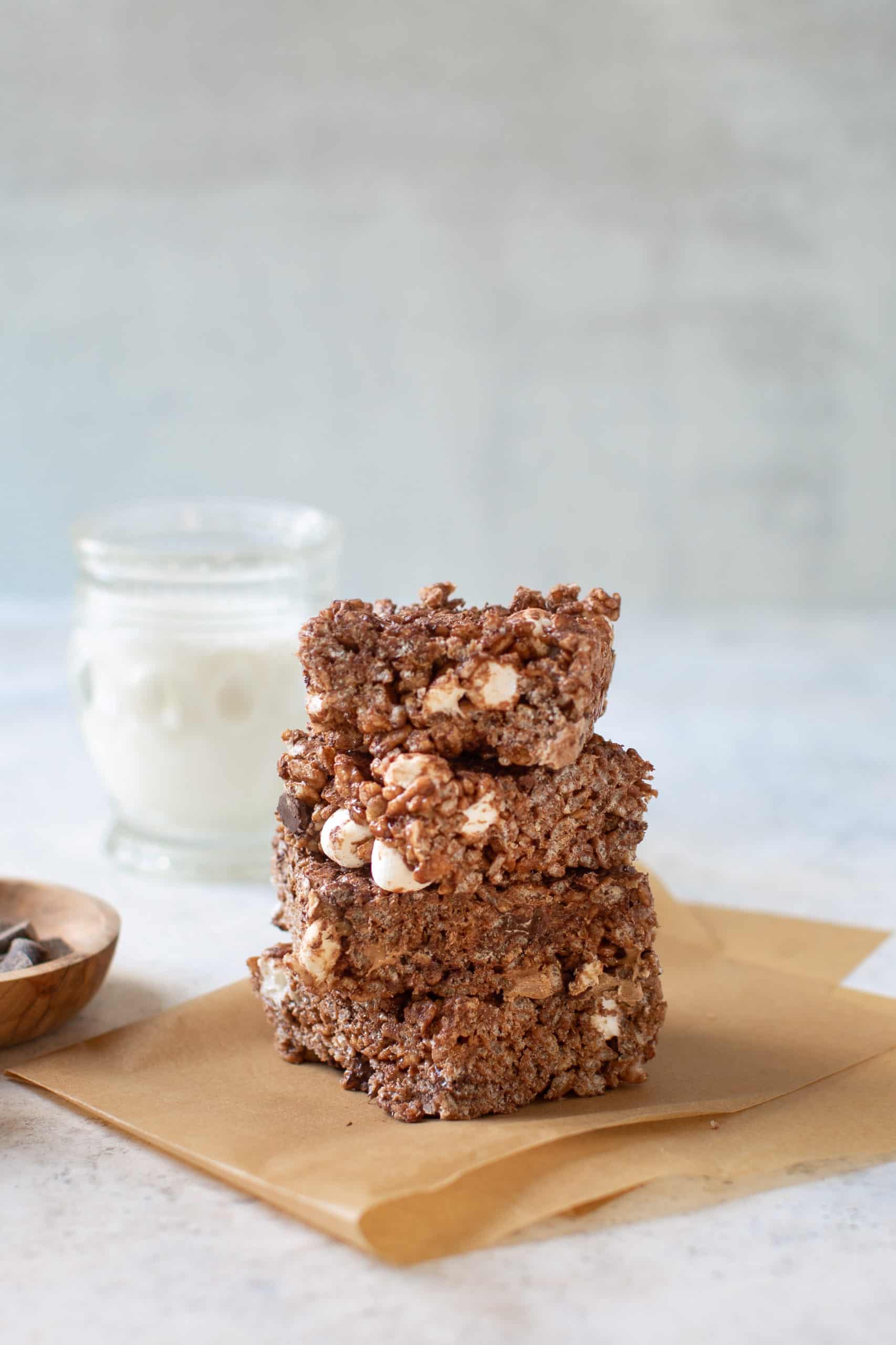 A stack of chocolate rice krispy treats on a piece of paper.