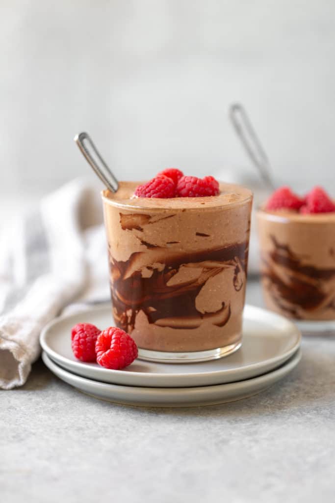 mocha chocolate smoothie in a glass with raspberries