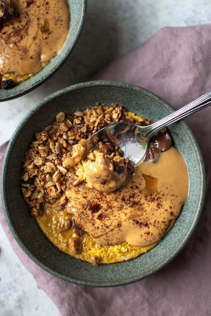 pumpkin baked oatmeal in a bowl with a spoon
