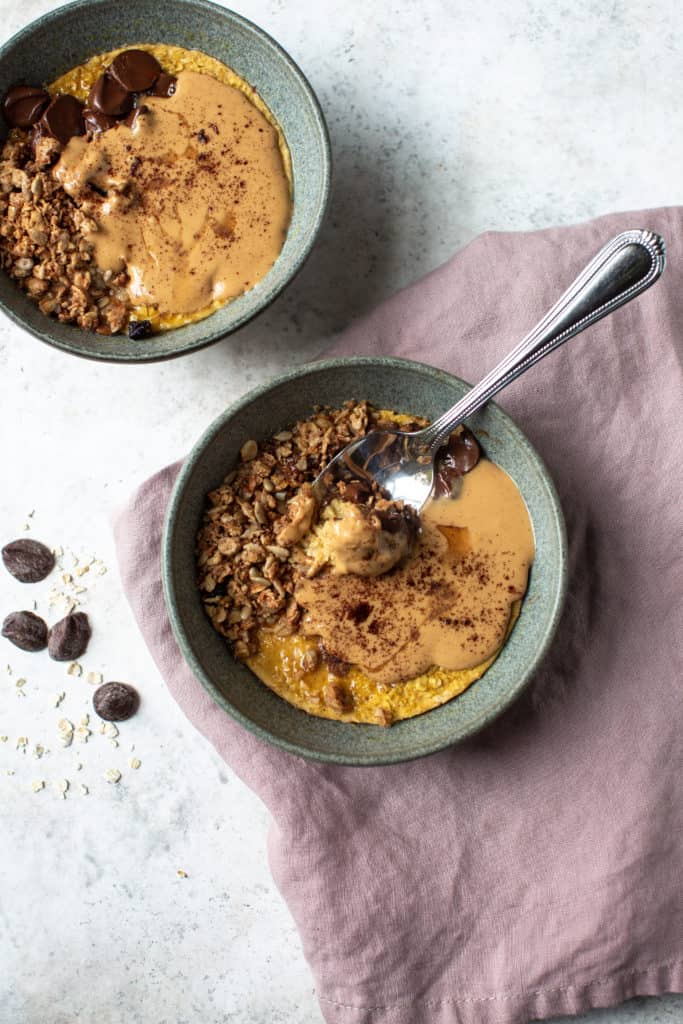 baked pumpkin oatmeal in microwave with chocolate and granola topping