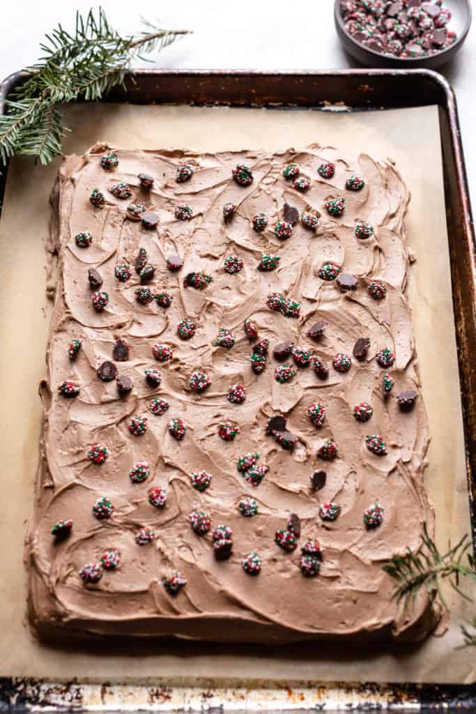 full chocolate cake on a sheet pan with sprinkles