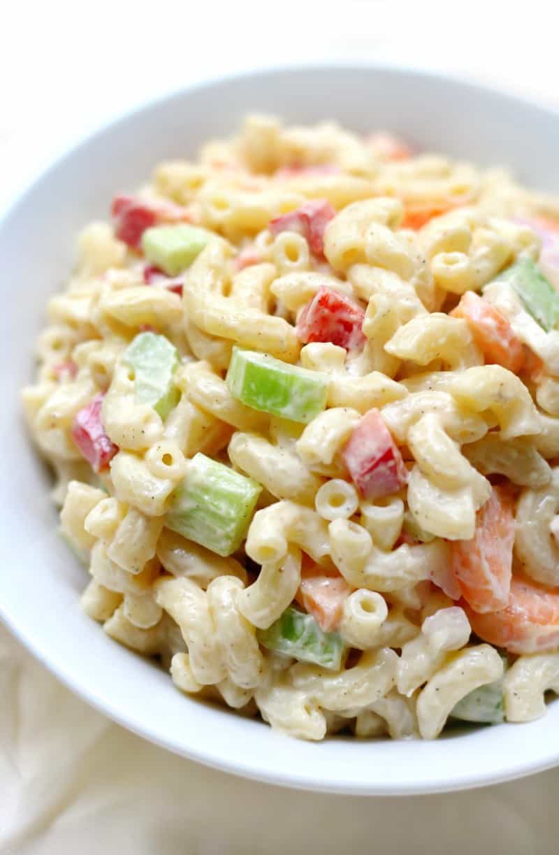 A bowl of gluten-free macaroni salad with vegetables and shrimp.