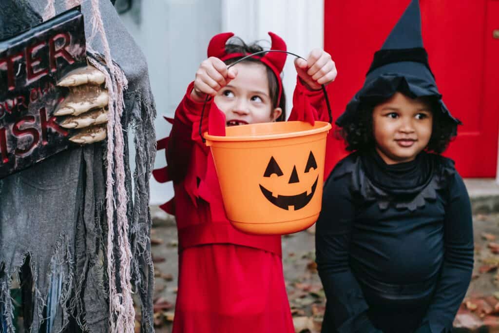 trick or treaters with candy pail