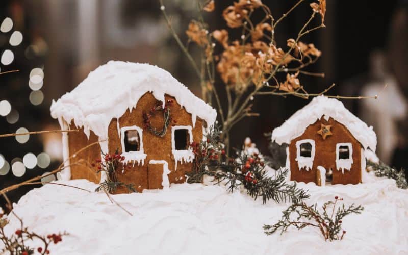 country gingerbread house with trees, snow and white roof