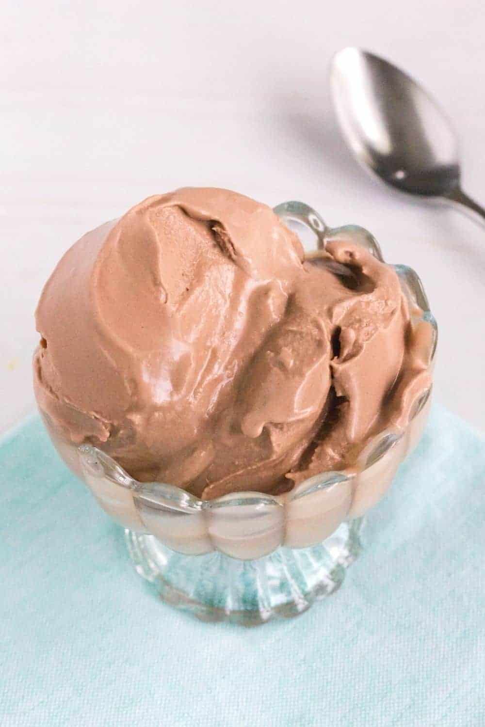 A bowl of chocolate ice cream on a napkin.