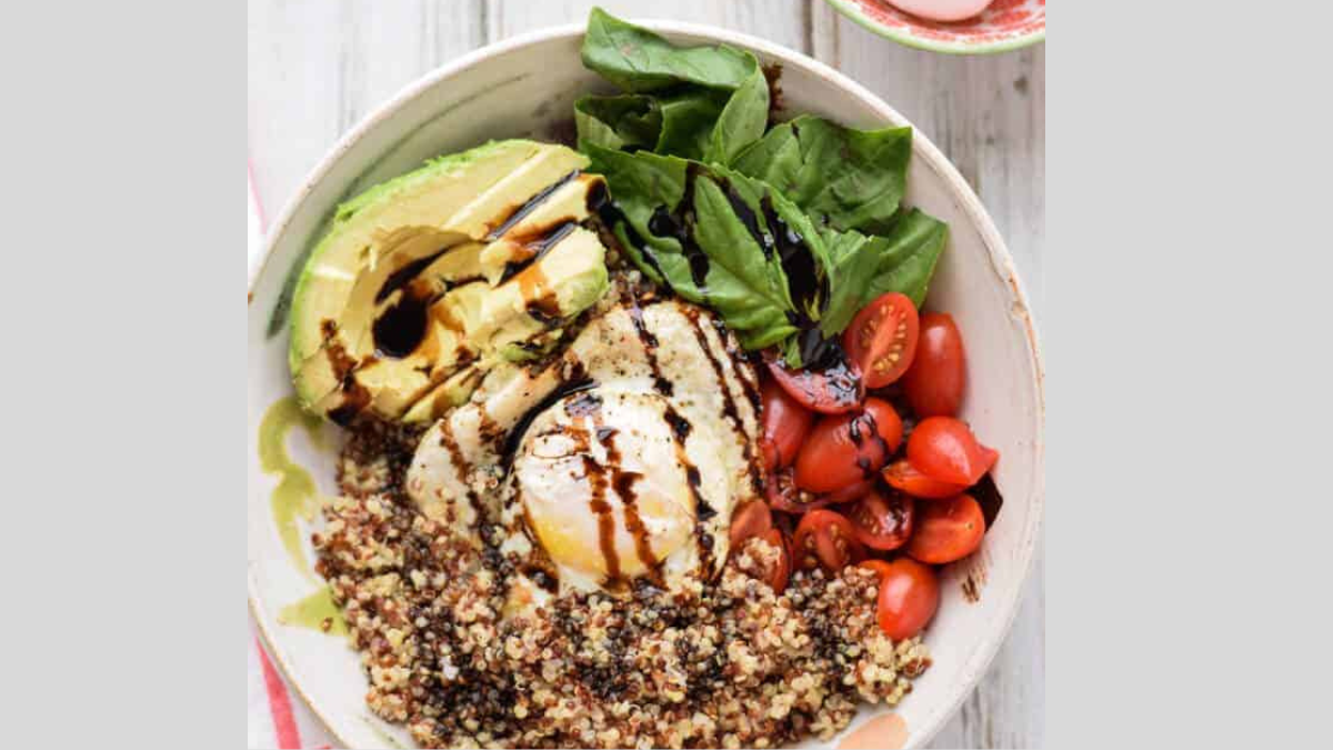 Quinoa breakfast bowl with avocado, tomatoes, and egg