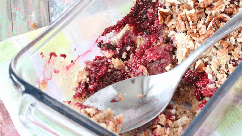 triple berry crumble with a spoon