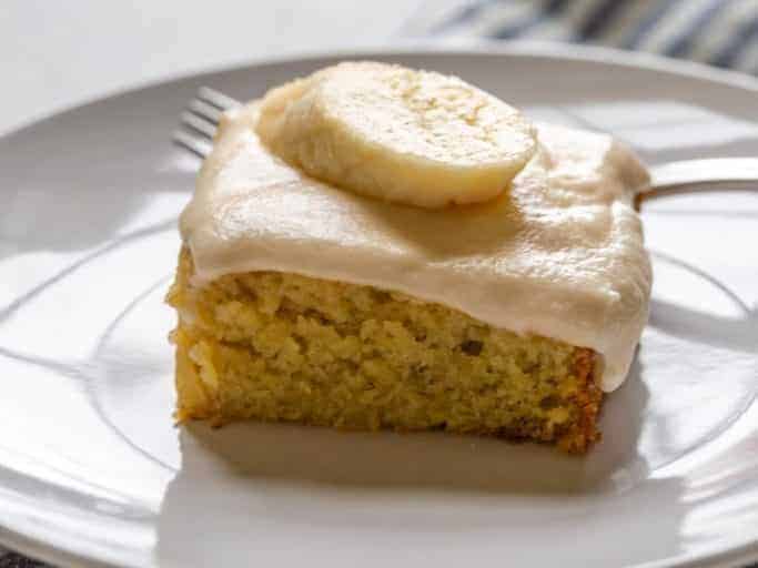 close up of banana cake with buttercream frosting