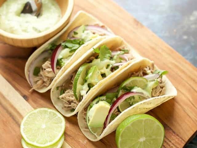 Instant Pot Pork Tacos with avocado and onion.