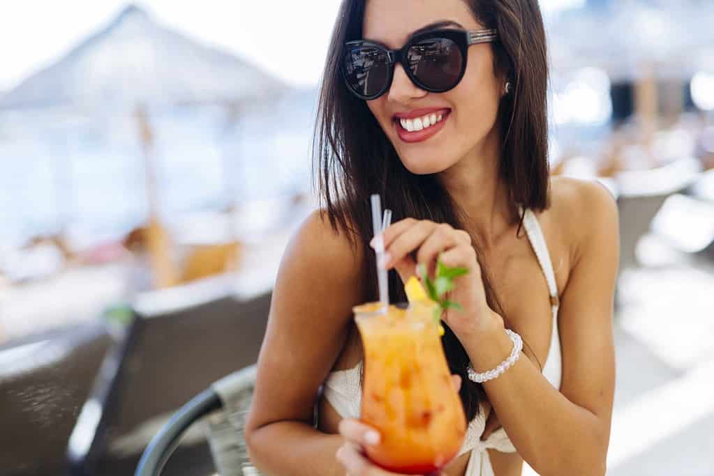  woman drinking cocktail in summer