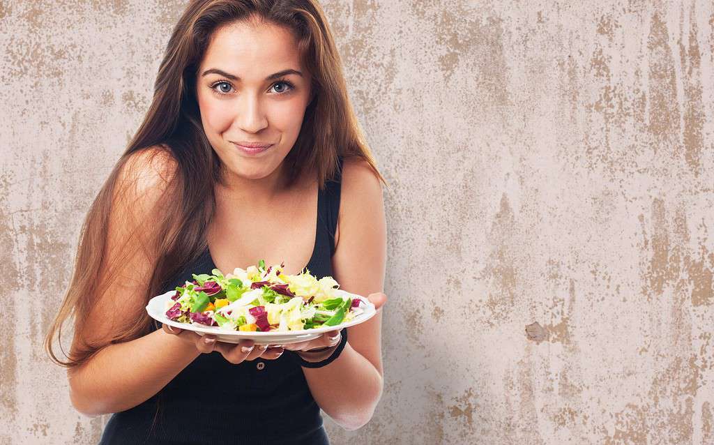 portrait of pretty young woman with a salad