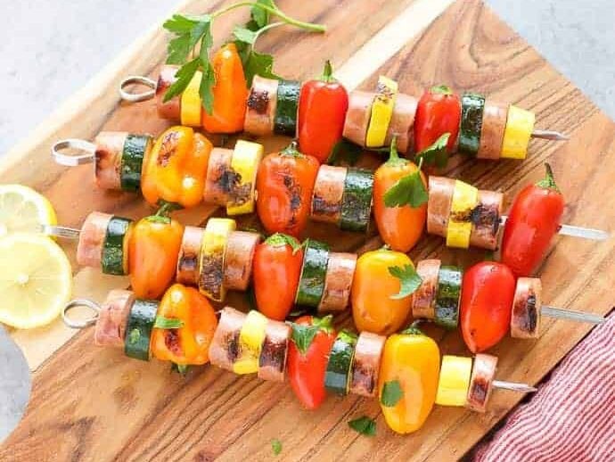 Chicken Sausage Skewers with Vegetables on skewers on a cutting board