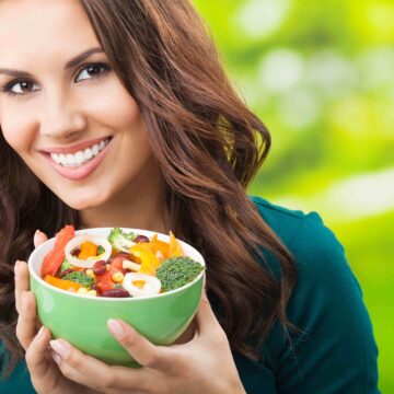 woman eating a salad outside