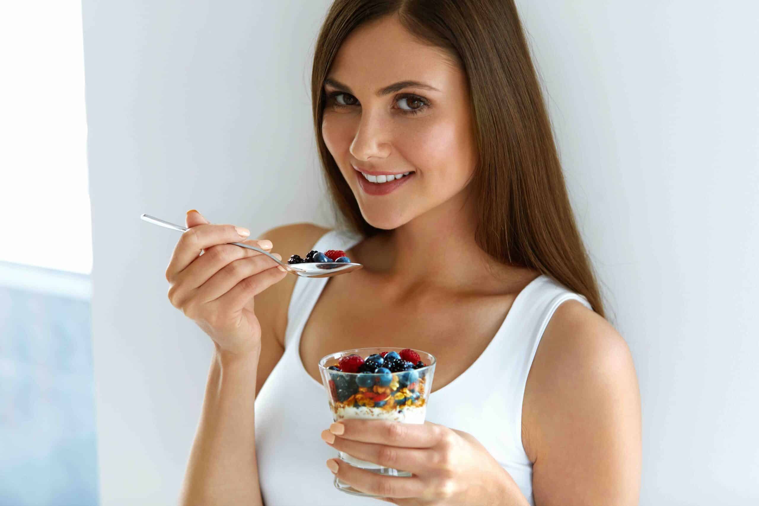 Healthy Weight Loss Food. Portrait Of Pretty Smiling Fit Girl Having Yogurt, Berries And Oatmeal. Beautiful Young Woman Eating Fresh Yoghurt, Berries And Granola For Breakfast. Diet Nutrition Concept