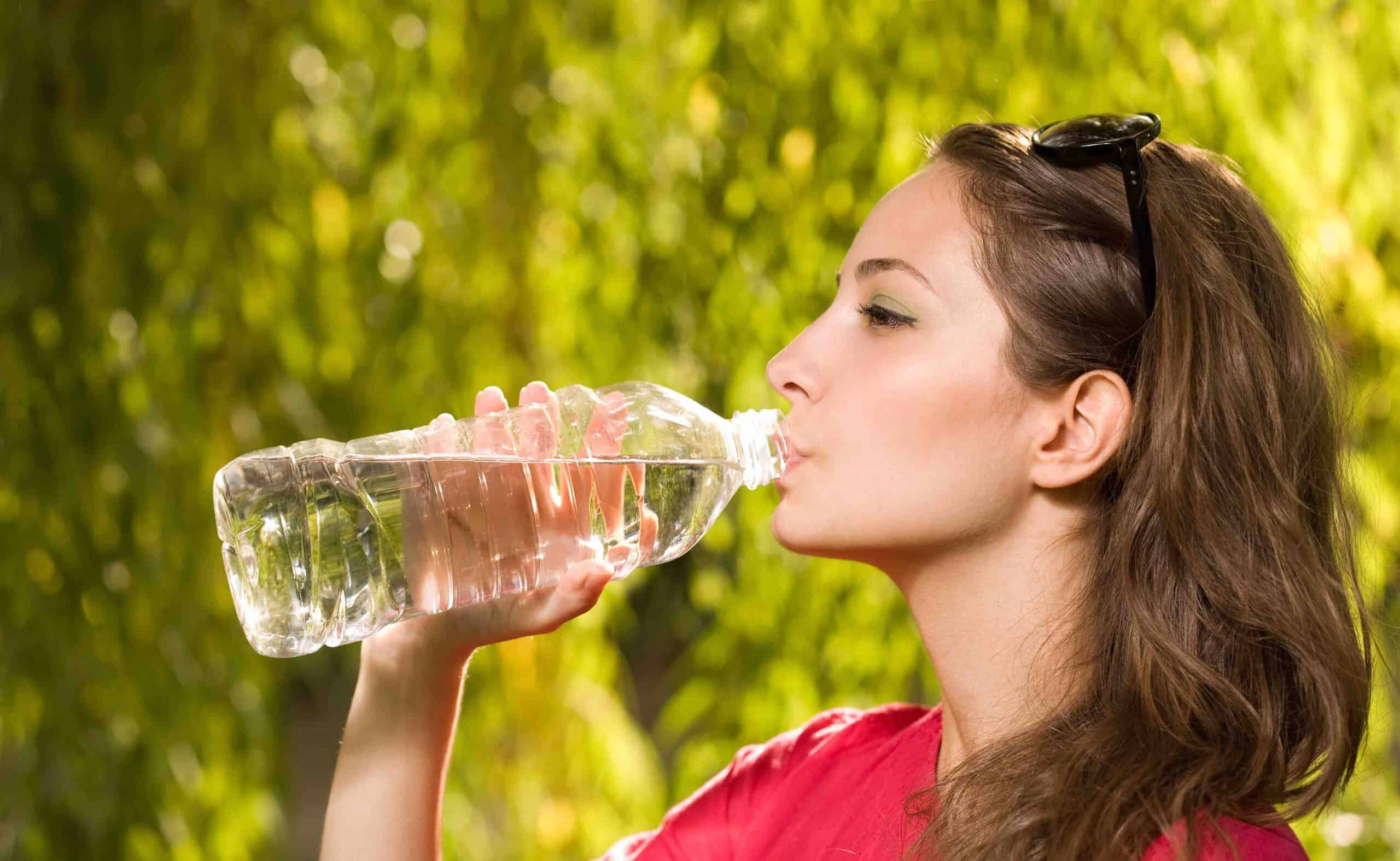 Precious water, gorgeous brunette woman with bottled water.