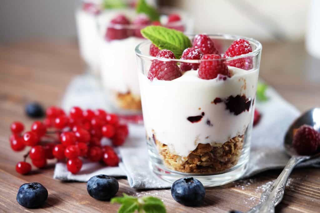 Natural yogurt with fresh berries and muesli. Healthy dessert. Close up.