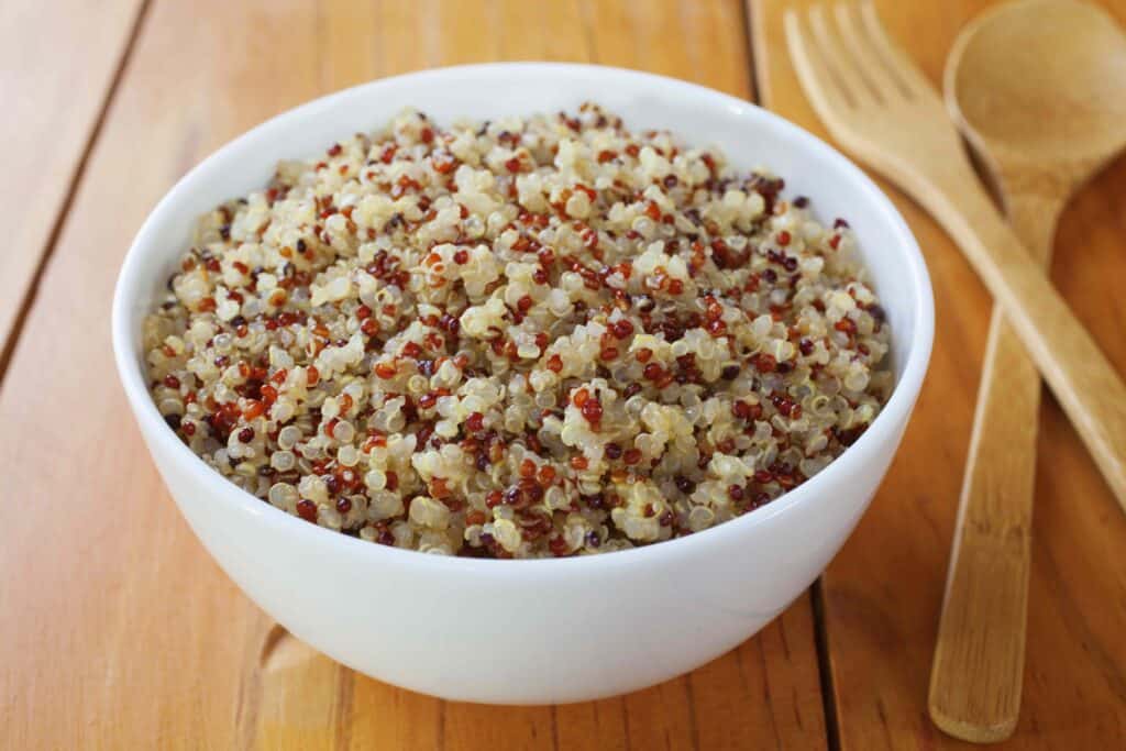 A bowl of cooked quinoa and amaranth. Contains red, white and black quinoa.