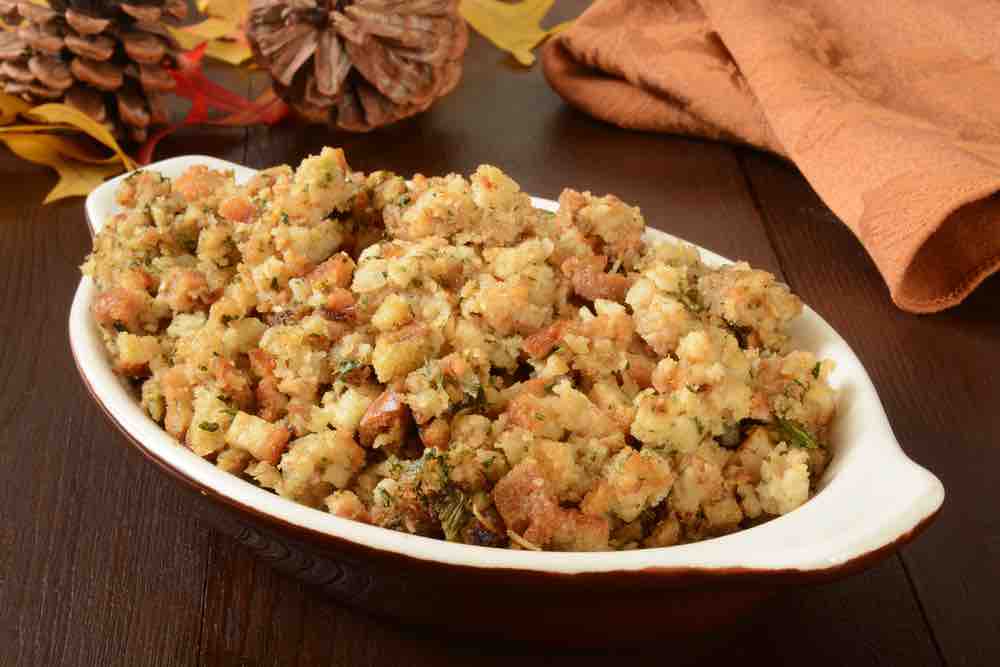 A small casserole dish of herbal holiday stuffing in turkey juice
