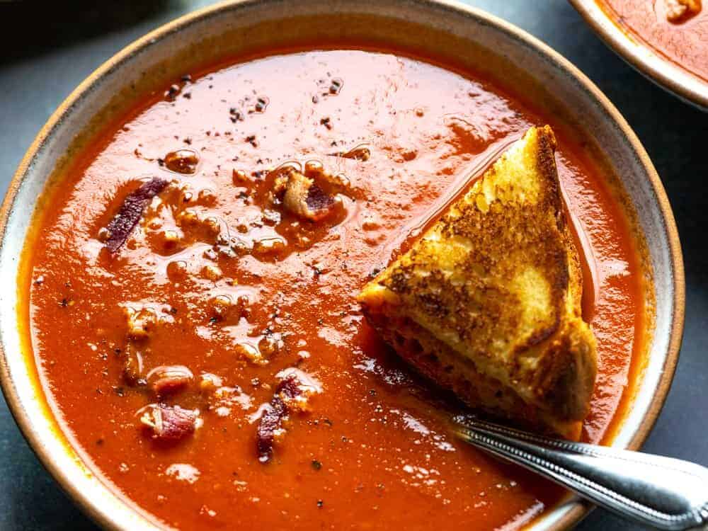 tomato soup in a bowl with a spoon.
