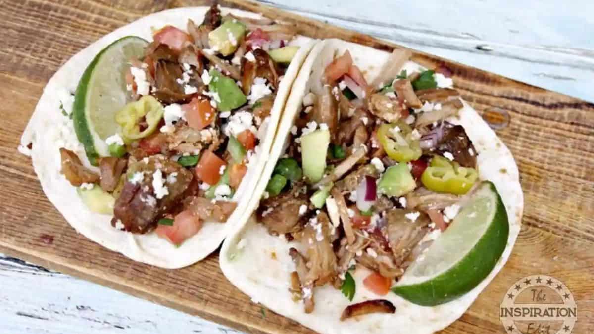 Tacos with salsa and pulled pork.
