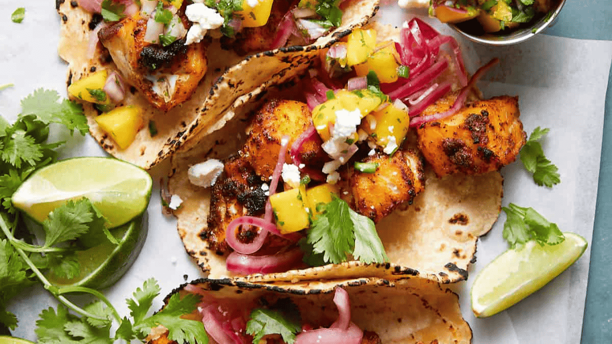 Fish tacos topped with salsa made of mango.