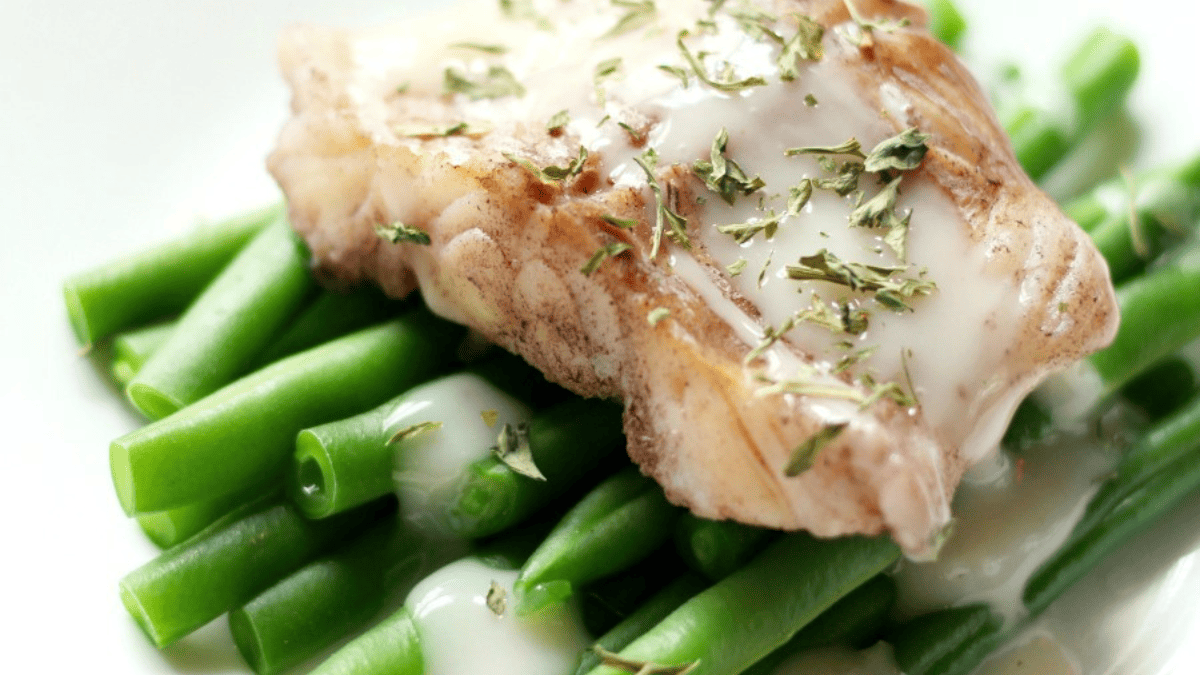Cod over green beans with sweet onion drizzle.