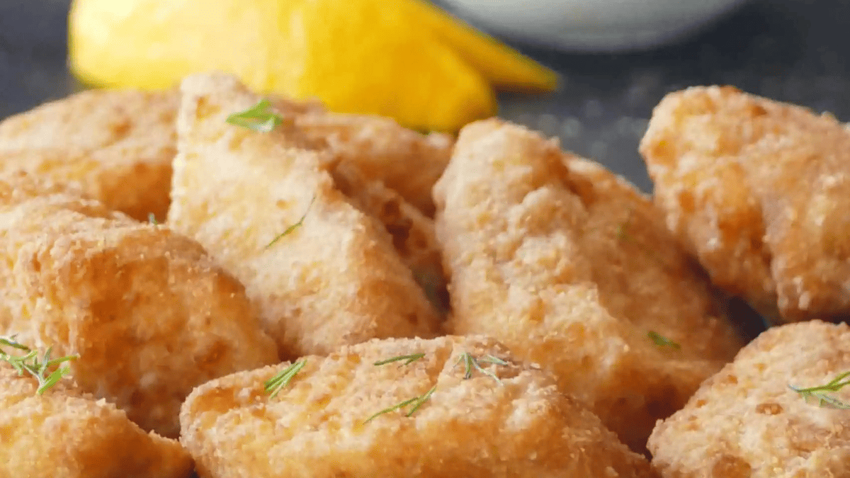 A plate of battered cod filets.