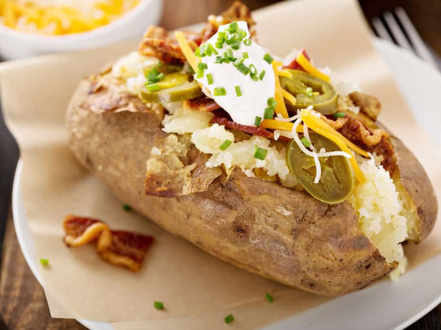 Loaded baked potato with bacon, cheese sour cream and chives