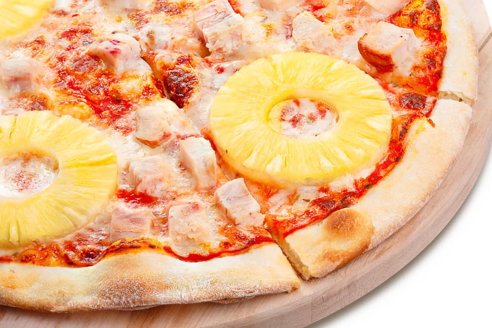 Neat, tasty and elegant pizza cooked from pineapple slices and ham.
