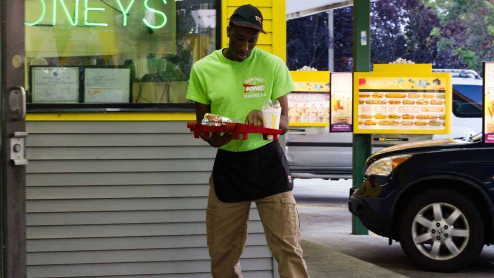 Greensboro, North Carolina / United States of America - July 30 2014: Sonic Fast Food restaurant chain with male waiter on roller blades to serve food
