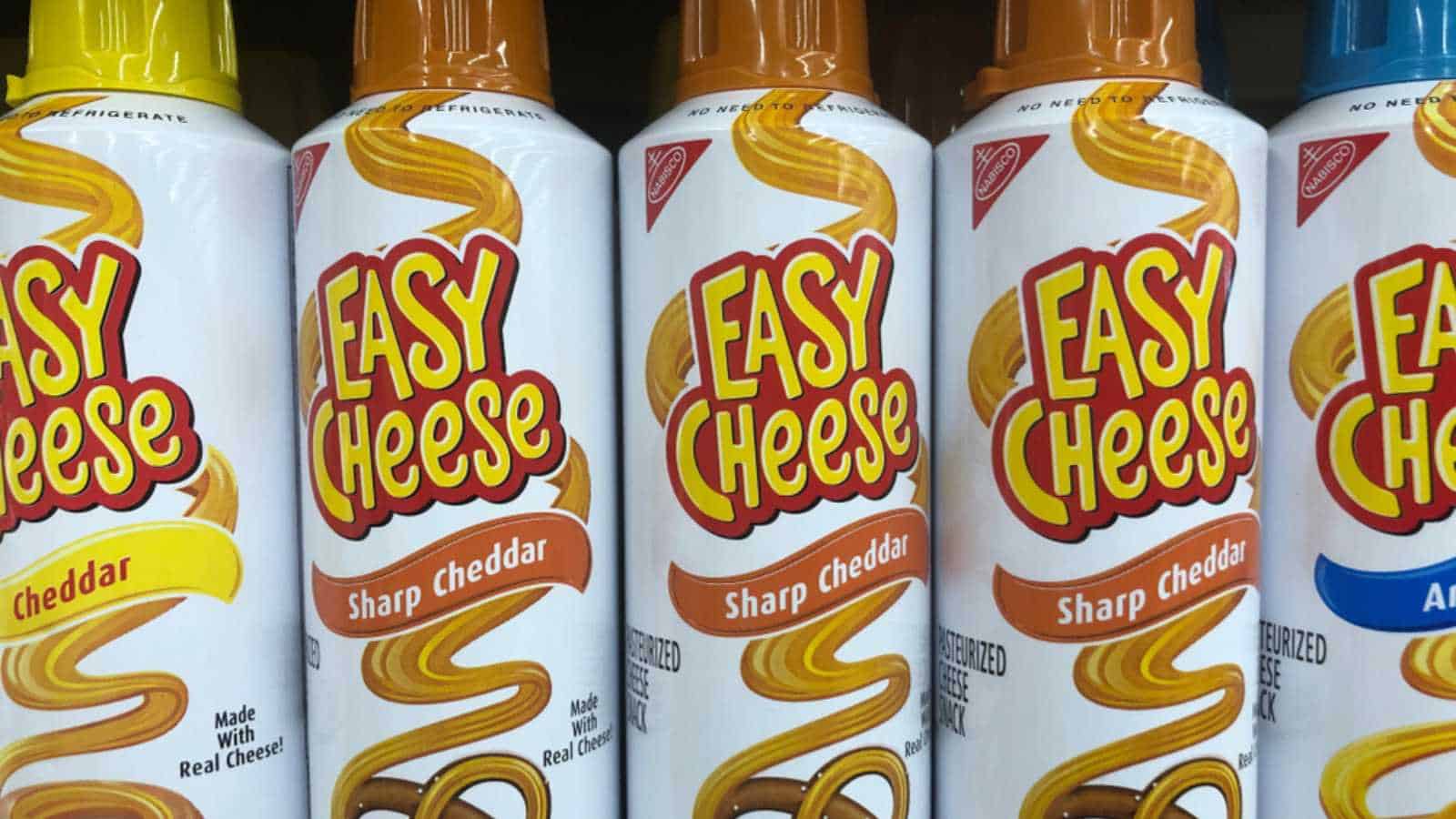 March 13, 2019: Minneapolis, MN: Cans of Nabisco easy cheese in various flavors on a grocery store shelf.
