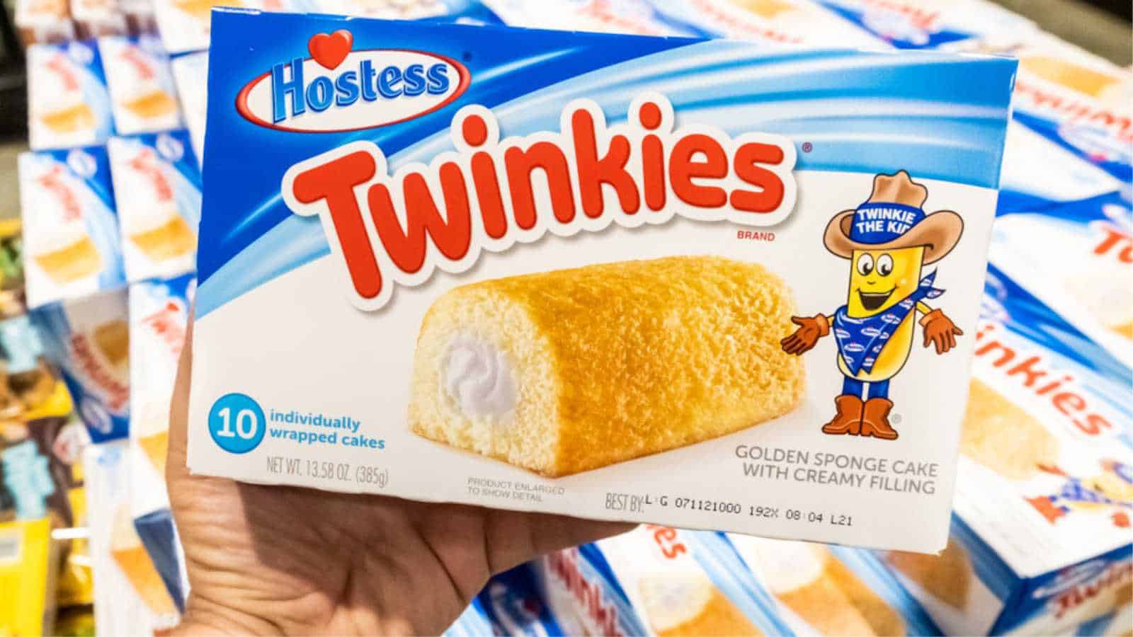 Los Angeles, CA/USA 08/20/2019 Shoppers hand holding a package of Twinkies brand golden sponge cakes with creamy filling in a supermarket aisle
