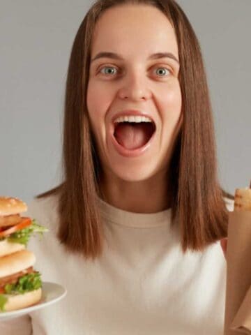 Woman with burger and hotdogs