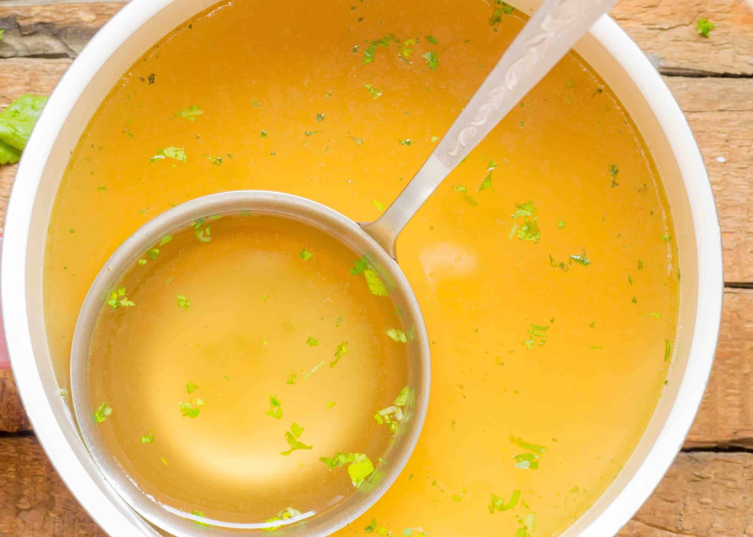 Saucepan with broth on the table top view