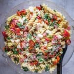 A gluten-free pasta salad with ham and tomatoes.