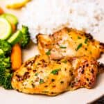 Grilled chicken with rice and vegetables on a plate, accompanied by 30 Air Fryer Chicken Recipes.
