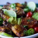 30 Air Fryer Chicken Recipes featuring a plate with chicken wings, tomatoes, and limes.