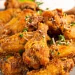 30 Air Fryer Chicken Recipes featuring chicken wings on a plate with celery.
