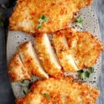 30 Air Fryer Chicken Recipes with fried chicken breasts on a plate, sauce on the side.