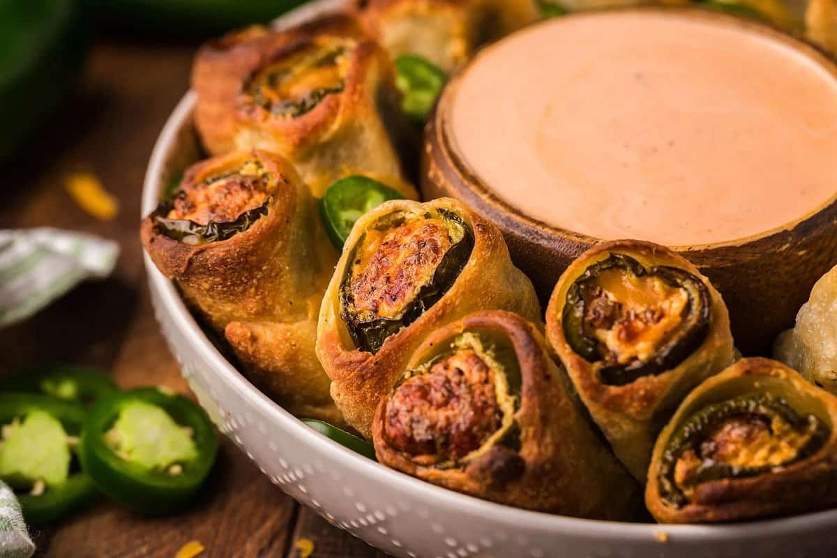 Recipes Using Crescent Rolls - Jalapeno spring rolls with dipping sauce in a bowl.