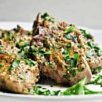 50 Easy Gluten Free Dinners featuring Grilled lamb chops on a white plate with herbs.